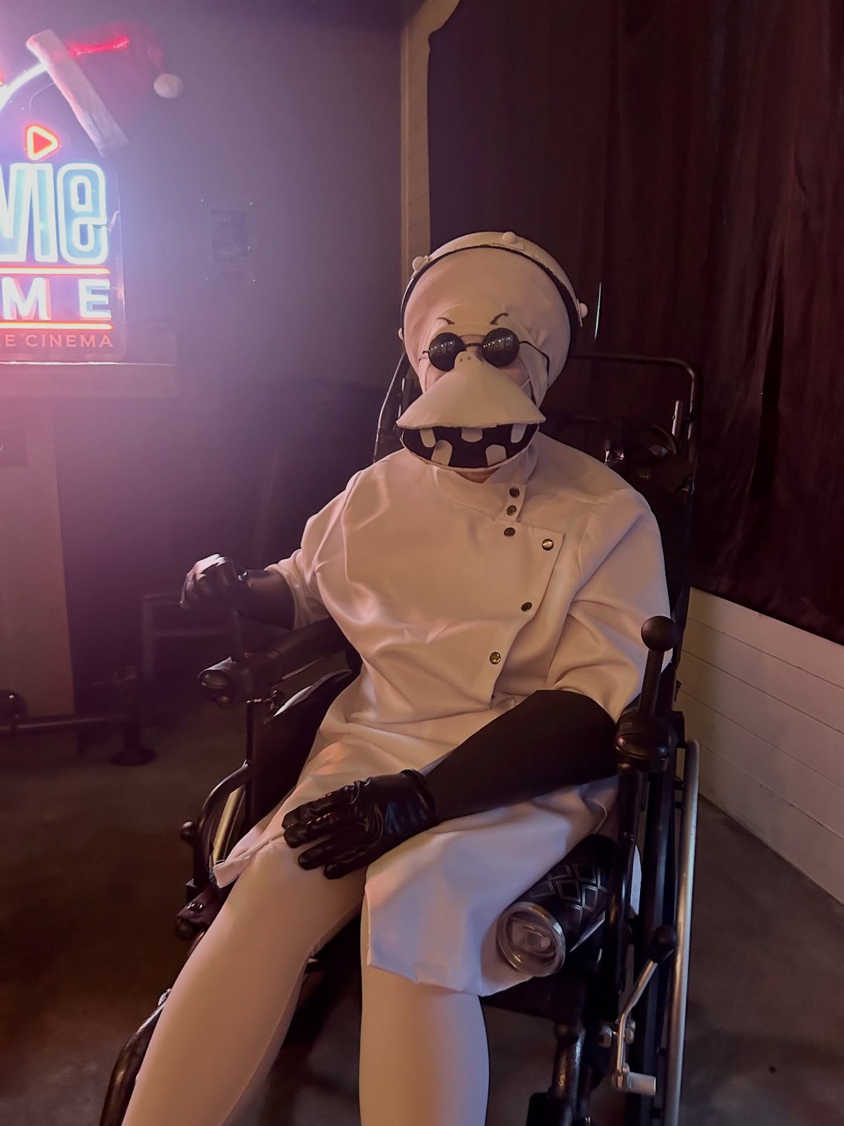 A Movie Thyme guest in a white costume and round sunglasses
