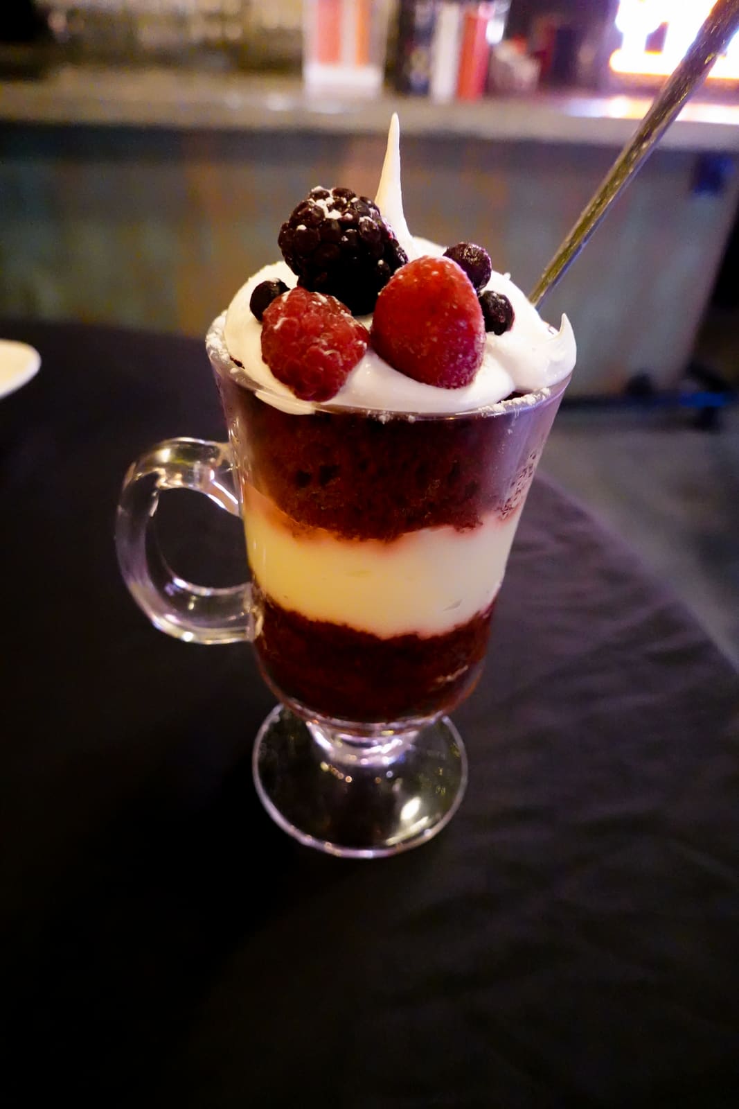 Close-up of a layered berry-and-cream parfait in a glass
