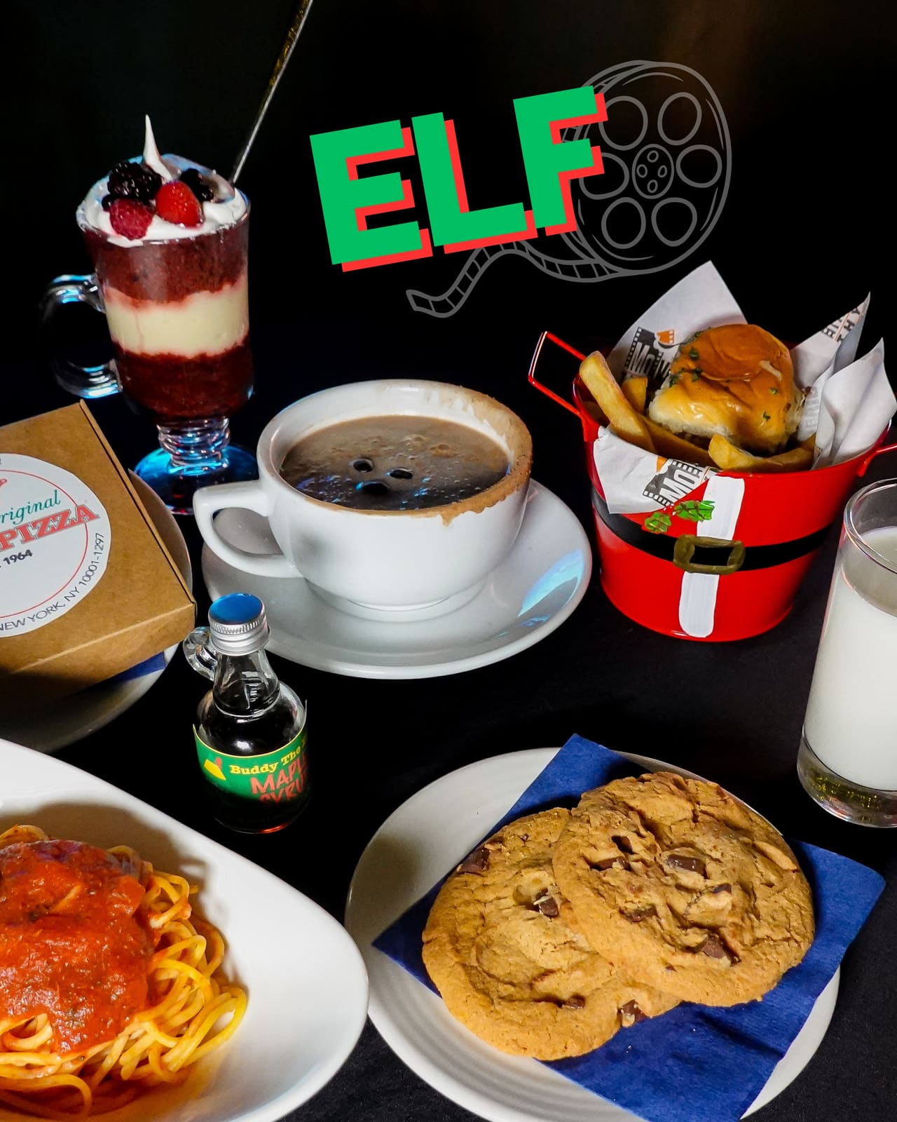 Elf title graphic above a table with a pizza box, parfait, coffee and fries